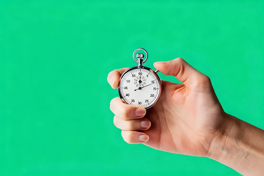 A hand holding a timer